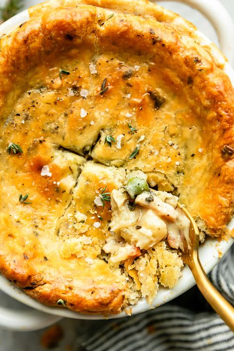 The classic comfort food dinner recipe, made mini: Individual Chicken Pot Pie! A creamy pot pie filling with tender chicken & hearty vegetables is individually portioned & topped with homemade all-butter pot pie crust studded with fresh herbs for extra savory flavor. Bake until the pastry is flaky & golden for a super cozy dinner. Great for date night or any chilly winter evening! (Easy make-ahead instructions provided.) #chickenpotpie #potpiecrust #individualchickenpotpies #minichickenpotpies Creamy Pot Pie, Pot Pie Crust, Individual Chicken Pot Pies, Mini Pot Pies, Chicken Pot Pie Filling, Savory Tarts, Mini Chicken Pot Pies, Pot Pie Filling, Cozy Dinner