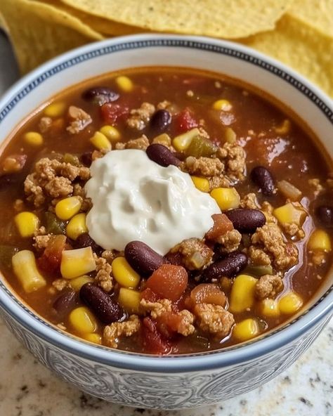 🌮 Taco Soup 🌮 This taco soup is packed with flavor and simple to make, offering a warm and hearty meal in no time. Loaded with beef, beans, and spices, it's the perfect comfort food. Ingredients - 1 lb hamburger - 1 small onion, chopped - 1 can (15 oz) black beans, drained - 1 can (15 oz) kidney beans, drained - 1 can (15 oz) corn, drained - 1 can (10 oz) diced tomatoes with green chilies - 1 packet taco seasoning - 1 packet ranch seasoning - 2 cups beef broth - Salt and pepper to... Comfort Recipes, Chicken Noodle Soup Easy, Vegetarian Soup Recipes, Winter Cooking, Random Aesthetics, Hearty Meal, Soup Recipes Chicken Noodle, Soup Season, Diced Tomatoes