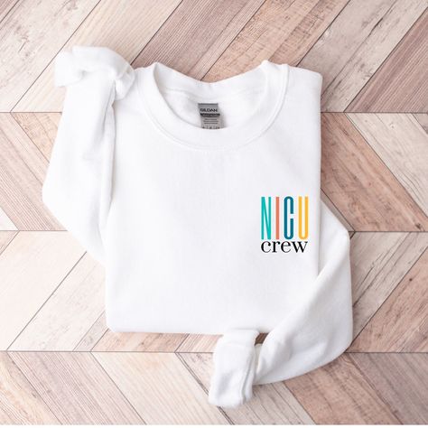 This colorful NICU Crew Sweatshirt would be perfect for any Neonatal Intensive Care Nurse or other staff working in the unit!  It would make a great nurse appreciation gift for any NICU Nurse, IC Nursery Nurse and Newborn Nurse working in your hospital. This Nurse/Crew pullover/sweater is super soft and bound to keep one warm in the upcoming fall/winter months. Unisex Sizes .: Gildan Crewneck Sweatshirt  .: 50% Cotton 50% Polyester .: Medium-heavy fabric .: Loose fit .: Sewn in label .: Runs tru Nursing Hoodie, Neonatal Intensive Care Unit, Nurse Appreciation Gifts, The Only Exception, Nurse Graduation Gift, Health Shirt, Nicu Nurse, Nurse Sweatshirt, Nurse Appreciation