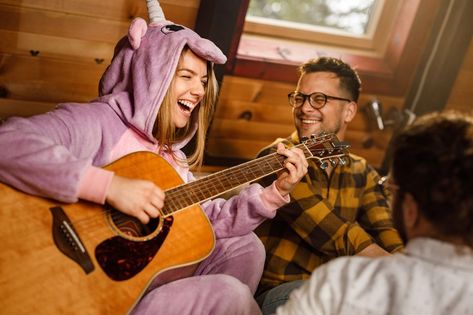 Cheerful woman playing a guitar dresses as unicorn Playing A Guitar, Unstructured Play, Adverse Childhood Experiences, Licensed Clinical Social Worker, Younger Self, Health And Wellness Coach, Carl Jung, Wellness Coach, Inner Child