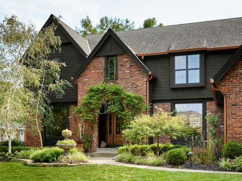 1980s Home Remodel Exterior, Brick House With Dark Siding, Red Brick Dark Siding, Black Siding With Brick, Red Brick Craftsman Exterior, Red Brick With Black Siding, Black Soffit And Fascia Red Brick, Red Brick And Black Exterior, Black And Brick House Exterior