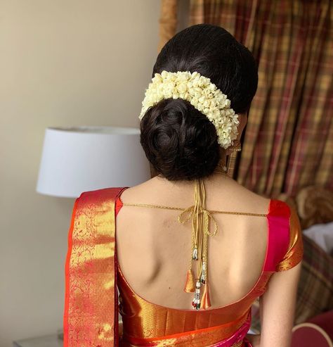 What a beautiful large low bun with real flower gajra! Care however should be taken before adopting such hairstyles, as due to it's high static charge, it will cause phlegm to move up in the throat, causing the voice to quaver & a frequent urge to clear the throat. A heavy chabi chhalla with a long & wide hook if inserted at the edge of the pleats of the saree, will reduce this problem as it's hook will activate the acupressure points that act to keep the throat clear. Low Bun Hairstyles Indian, Bun Hairstyles Indian Saree, Hairstyles Indian Saree, Bun Hairstyles Indian, Hairstyle For Saree, Indian Bun Hairstyles, Bridal Hair Decorations, Bridal Hairstyle Indian Wedding, Wedding Bun