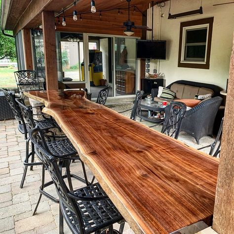 Outdoor Bar Tops Ideas, Live Edge Outdoor Bar Top, Back Porch Bar Table, Bar On Porch, Patio Railing Bar Top, Bar On Deck Ideas, Live Edge Bar Top With Epoxy, Black Walnut Bar Top, Under Deck Bar