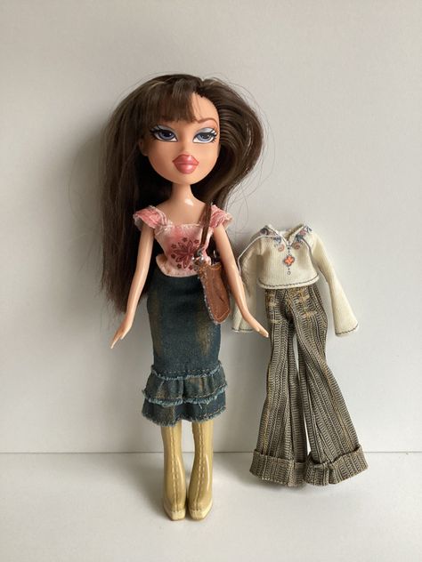 Original 2000s era Bratz doll by MGA: Style It Dana. Dana is a blue-eyed brunette with a pale complexion. She is fully dressed in one of her original outfits and includes an extra top and pants and her purse. She only had one pair of boots as pictured. Dana is in very good condition. Hair is smooth and doesn't appear to have been trimmed. There are a few pieces to the shorter side of her part that look longer because they're combed to the wrong side. Face paint is perfect. No nibbles to fingers Bratz Pants Outfit, Bratz Style It, W Outfits, Brown Boots Outfit, Vintage Strawberry Shortcake Dolls, 2000s Era, Condition Hair, Pale Complexion, Bratz Doll Outfits