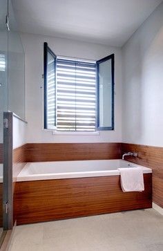 Like the wood or wood-like tiles on front face of tub. Tub Skirt, Tub Surround Ideas, Shower Alcove, Tub Surrounds, Wood Tub, Black Bathtub, Master Bath Design, Modern Tub, Modern Bathroom Remodel