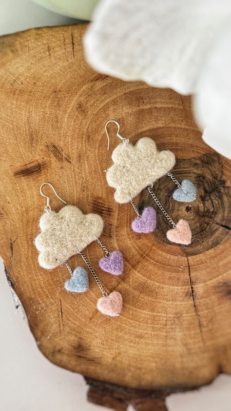 ꧁About the item ꧂ ▪️Add a touch of whimsy to your jewelry collection with these handmade felt cloud earrings. Made from soft and cozy 100% merino wool felt, each earring features three adorable heart charms that add a touch of sweetness to the design. The earrings are lightweight and comfortable to wear, making them the perfect accessory for everyday wear. The hooks are made with 925 Sterling Silver Plated, ensuring their durability and longevity. These earrings are perfect for those who appreci Felted Wool Earrings, Needle Felt Earrings, Hand Made Earings, Felt Cloud, Felt Earrings, Tovad Ull, Sky Jewelry, Felted Jewelry, Rain Earrings