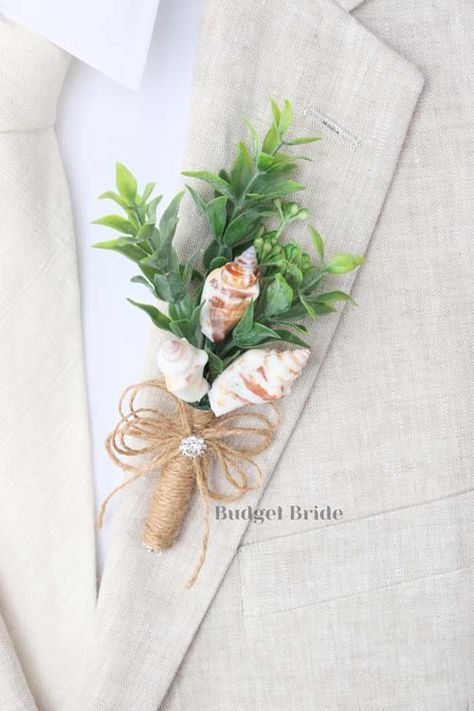 Mens lapel boutonniere with 3 seashells accented with foliage. The stems of the are wrapped with twine and accented with twine bow and jewel. Seashell Bouquet Wedding, Boho Beach Wedding Bouquet, Beach Boutonniere, Beach Themed Wedding Ideas, Seashell Boutonniere, Simple Beach Wedding Ideas, Lapel Boutonniere, Beach Wedding Boutonniere, Dr Wedding