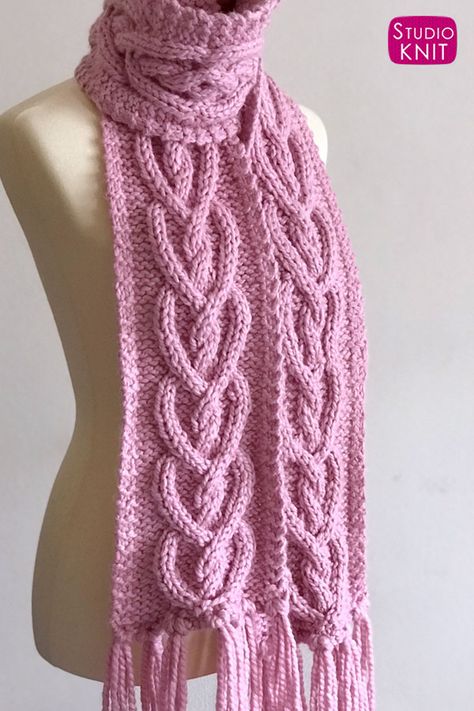 So sweet! Knit up a Celtic Cable Heart Scarf for your next gift filled with love. Knitted with super bulky yarn and large needles, this is a quick knit project that looks really impressive. This Heart Cable Knit Scarf Pattern is a sweet intermediate level project. #StudioKnit #scarfpattern #cableknit #cablescarf #knitscarf #freeknitingpattern Heart Knit Pattern, Cable Knit Scarf Pattern, Knit Scarf Pattern, Knitted Heart Pattern, Heart Scarf, Cable Scarf, Cable Knitting Patterns, Studio Knit, Knit Scarves