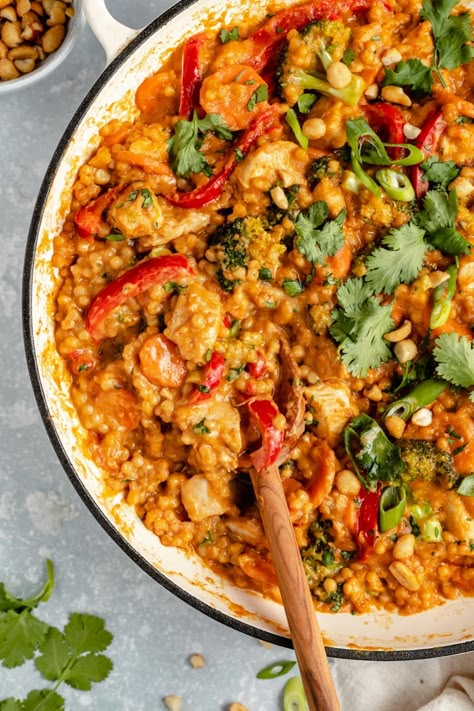 Delicious one pan Thai peanut chicken couscous packed with protein and a boost of colorful veggies. This cozy chicken couscous recipe is filled with Thai flavors thanks to a rich and creamy peanut sauce made with coconut milk, fresh ginger, soy sauce, garlic and creamy peanut butter. Options to add a kick of heat if you love spice! #thaifood #couscous #healthydinner Thai Flavors, Chicken Couscous, Couscous Recipe, Colorful Veggies, Thai Peanut Chicken, Gluten Free Soy Sauce, Ambitious Kitchen, Couscous Recipes, Thai Peanut