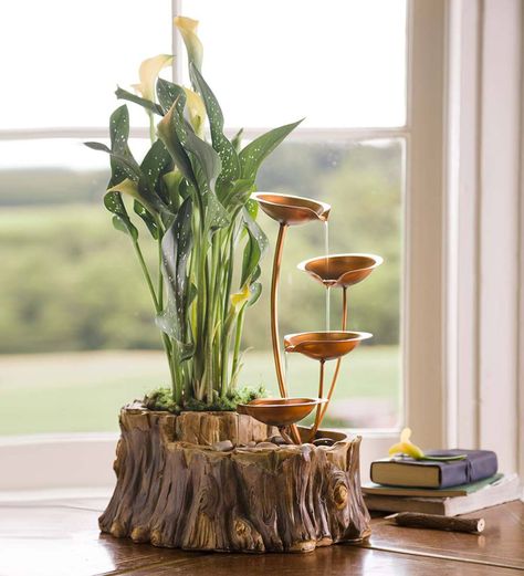 Beautiful sights and sounds of nature come together in this delightful Tabletop Fountain with Planter. Water trickles down four brass-colored metal bowls into the rock-filled base. Cast in resin, the base mimics the look of a tree trunk complete with knots and weathered bark. A whole in the base is large enough to accommodate a four-inch potted plant (not included). Water is recirculated by a quiet electric pump, so the only sound you'll hear is the peaceful trickling of water from one bowl t Indoor Tabletop Water Fountain, Diy Water Feature, Taman Air, Indoor Water Features, Indoor Water Garden, Diy Water Fountain, Tabletop Water Fountain, Diy Table Top, Diy Fountain