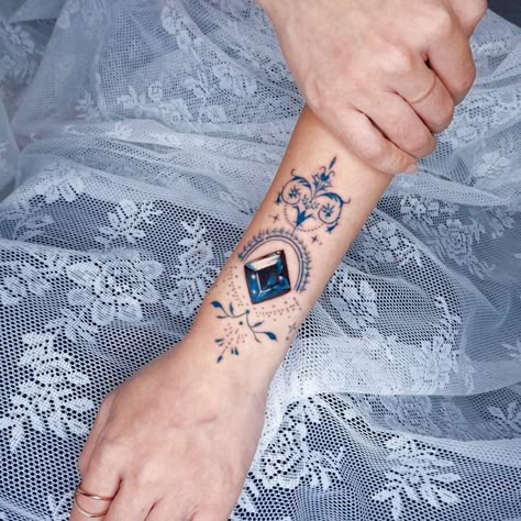 Blue Gem Tattoo, Blue Topaz Tattoo, Tattoo Gemstone, Jewel Tattoo Gem, Tattoos Symbols And Meanings, Birthstone Tattoos, Tattoos With Color, Gold Tattoo Ink, Black And Blue Tattoo