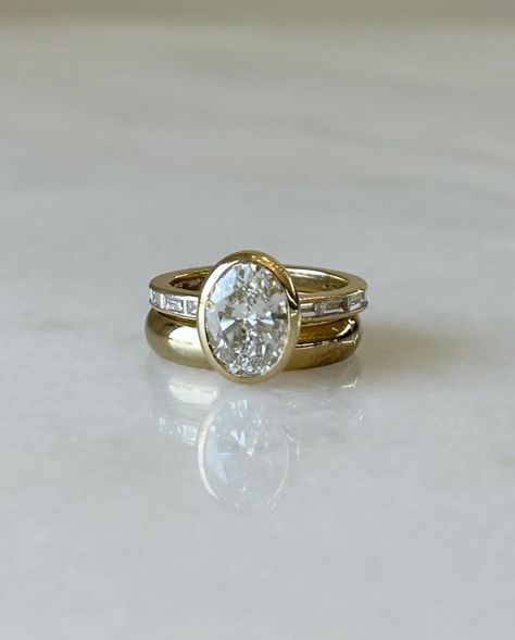 In love with this Oval Cut Diamond set in a Yellow Gold Bezel Setting 🤍 The East West Baguettes on its side are so incredibly unique. We’re obsessed!! Unique East West Engagement Ring, Bezel Set Engagement Ring Stack, Horizontal Oval Engagement Ring, Engagement Plan, Oval Engagement Ring, Future Engagement Rings, Oval Engagement, Bezel Ring, Engagement Rings Oval