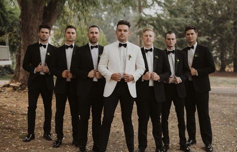 Cream White Tuxedo Wedding, Black Tux With Champagne Vest, Black And White Tuxedo Wedding Groomsmen, Groomsmen Attire White And Black, Black Tux Wedding Cummerbund, White Tux Black Shirt, Cream Jacket Black Pants Groom, White Groom Black Groomsmen, Tan Jacket Black Pants Wedding