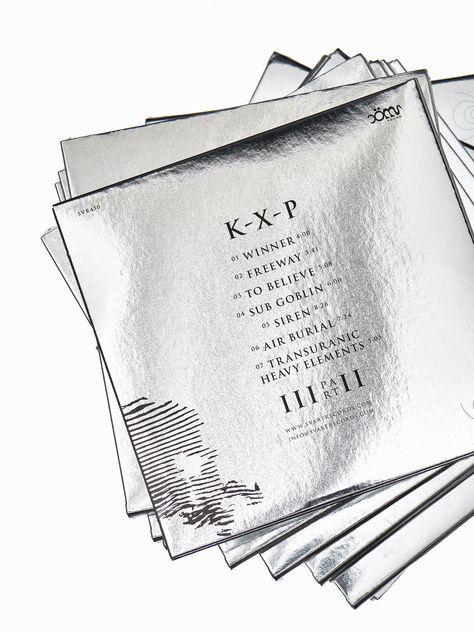 Silver Foil Invitation, Chrome Branding, Metallic Graphic Design, Mirror Packaging, Grey Packaging, Foil Tags, Hang Tag Design, Foil Packaging, Manual Design