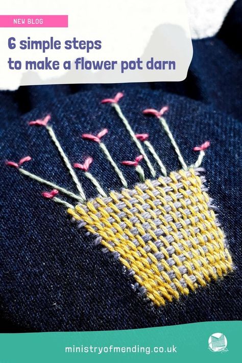 A woven repair made over a hole in denim fabric using colourful cotton thread. A flower pot/basket design with red tulip style flowers popping out of the basket. Darning A Hole With Embroidery, Darning Loom, Visible Mending Flower, How To Use A Darning Loom, Darning A Hole, Speedweve Darning Loom, Visible Mending Stitches Flower, Visible Mending Stitches, Couch Repair