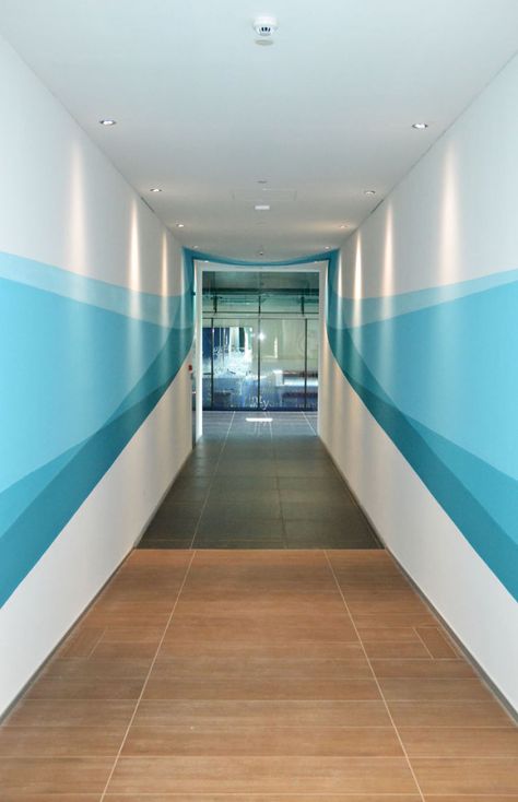 Our Mural Changes Shape As You Walk Through It Office Wall Design, Corridor Design, Wall Painting Ideas, Hospital Interior, School Interior, Walter Gropius, Hospital Interior Design, Hospital Design, Healthcare Design