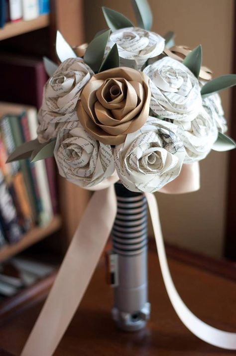 These Paper Roses Make The Most Beautiful Bouquets |  #alternative #bookbouquet #bookpage #bookpageboutonniere #bookpageflowers #bouquet #flower #flowergirl #flowergirlwand #paperboutonniere #paperflowerboutonniere #paperflowers #paperroses #upcycled #weddingflowers | paper roses Starwars Wedding Ideas, Harry Potter Star Wars Wedding, Star Wars Wedding Ideas, Wedding Star Wars, Star Wars Wedding Theme, Nerd Wedding, Geeky Wedding, Nerdy Wedding, Star Wars Light