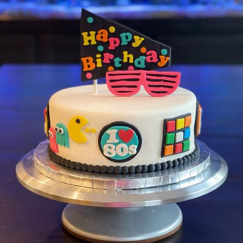 Shelli Smith on Instagram: “80s themed birthday cake for a grad school friend. This one was a fun one to make, love it when I get to be creative! (Scroll for a 360…” 80s Birthday Party Theme Cake, 1980s Cake 80s Theme, 1980s Birthday Cake, 80s Bday Cake, 1983 Birthday Cake, Retro Cake 80's, 80’s Cake, 80s Cake Ideas, 80s Theme Cake