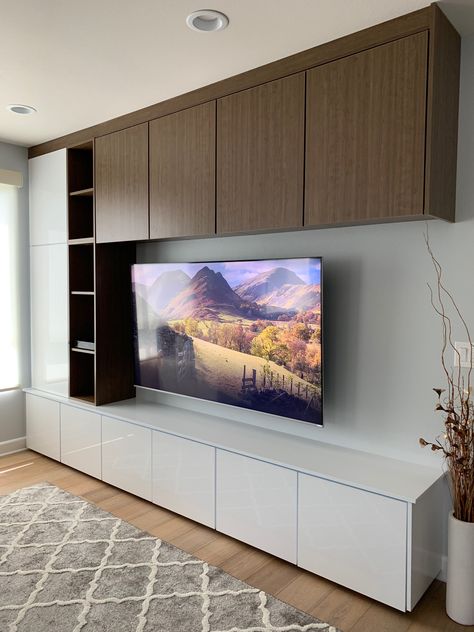 Two-tone TV wall with 75” TV.  White gloss panel from Europe and Canadian laminate wood grain. Tv Wall White Wood, Tv Cabinet White And Wood, Living Room Laminate Ideas, White And Wood Tv Unit, White And Wood Tv Wall, Tv Wall With Wood Panels, Besta Tv Wall Ideas, Tv Wall Design White, White Tv Wall Design