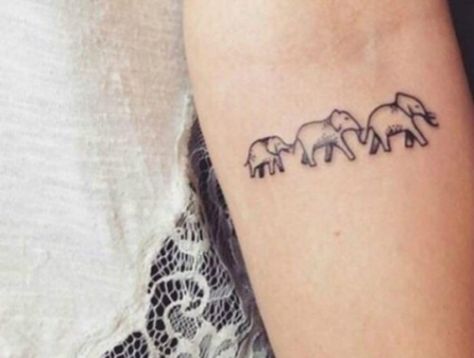 The  leader of a group of elephants is always an older female who fiercely protects and guides the young. This tattoo reminds you of the powerful, loyal woman with deep family values that you are. Tiny Elephant Tattoo, Elephant Tattoo Design, Tato Lengan, Small Tattoos With Meaning, Family Tattoo, Delicate Tattoo, Geniale Tattoos, Elephant Tattoo, Elephant Tattoos