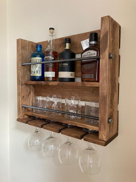 "WALL MOUNTED BAR, DOUBLE SHELF, WHISKY BAR, MINI BAR, BOTTLE & GLASS RACK RECLAIMED WOODEN BOTTLE/GLASS RACK Great Home & Garden bar this is the overall size needed for hanging due to weight we can not make this in any bigger size L 600mm H 500mm D 150mm Metal threaded bar decorative front 2 tier shelf for glasses & bottles, slots for hanging stemmed glasses Always use suitable wall plugs & screws for your wall type. The heavier the shelf, the longer the screws. For this reason Small Mini Bar Ideas, Bottle Rack Ideas, Mini Bar Ideas For Home, Mini Bar Wood, Wood Mini Bar, Mini Wine Bar, Shelf For Glasses, Whiskey Rack, Wooden Wine Bottle Holder