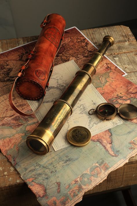 On order you get a rare working replica of an East India Company 1818 brass telescope . It's hand crafted in premium quality brass and fitted with high resolution optical lenses for great magnification. When stretched this brass telescope measures 32 inches and when collapsed it's merely 12 inches that makes it fit for easy storage and carrying. Comes in a hand stitched Leather case that has detailed markings and can be used as a carry case as well. Almost 900 gms weight approximately. High Resolution Optical DF Lens provide brilliant magnification in this large brass telescope Heavy & LARGE Telescope spyglass Measure 32 inches when stretched and 12 inches when collapsed. Spyglass Aesthetic, Old Telescope Aesthetic, Fantasy Telescope, Telescope Reference, Inventor Aesthetic, Telescope Aesthetic, Old Telescope, Small Telescope, Pirate Telescope