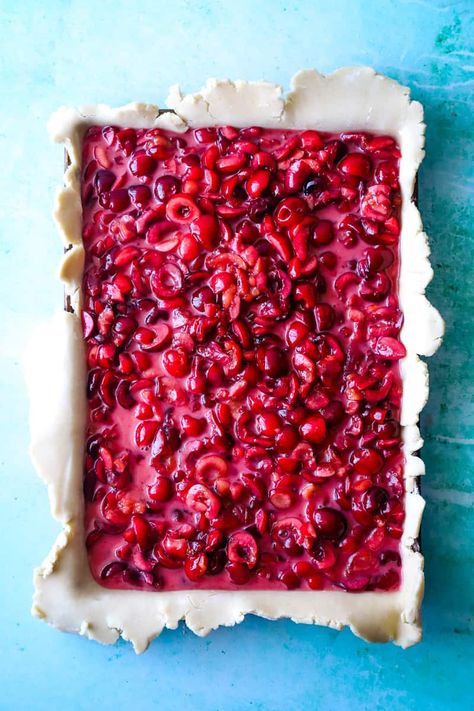 Overhead shot of the cherry pie filling in the pie dough lined sheet pan. Sheet Pan Pie, Cherry Slab Pie, Lattice Crust, Cherry Hand Pies, Cherry Pitter, Slab Pie, Fresh Cherry, Cherry Filling, Jelly Roll Pan