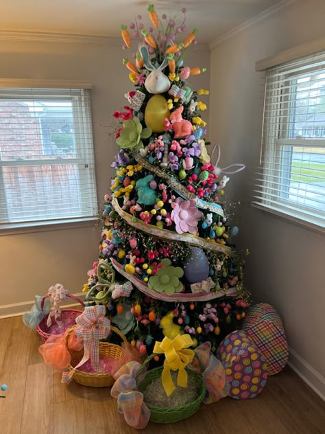 Christmas tree decorated for easter with faux flowers, lots of easter eggs, easter bunnies, rabbits, jelly beans, carrots, and ribbon! April Christmas Tree Ideas, Easter Trees Decorated, Seasonal Christmas Tree Ideas, Easter Trees Ideas, Spring Christmas Tree Ideas, Easter Christmas Tree Ideas, Christmas Tree All Year Round, Year Round Christmas Tree Ideas, Christmas Tree Year Round