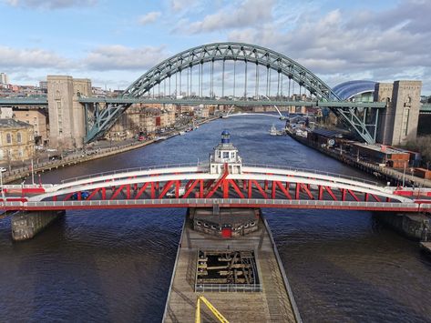 Newcastle upon Tyne is a university city on the River Tyne in northeast England. With its twin city, Gateshead, it was a major shipbuilding and manufacturing hub during the Industrial Revolution and is now a centre of business, arts and sciences. Spanning the Tyne, modern Gateshead Millennium Bridge, noted for its unique tilting aperture, is a symbol of the 2 cities. Gateshead Millennium Bridge, Millennium Bridge, The Industrial Revolution, Newcastle Upon Tyne, Industrial Revolution, Twin Cities, Newcastle, The River, Bridge