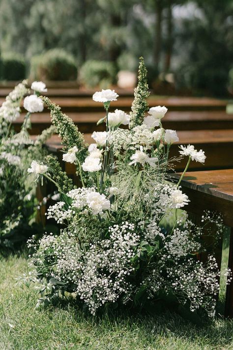 Dreamy aisle flowers go perfectly with an ethereal garden wedding