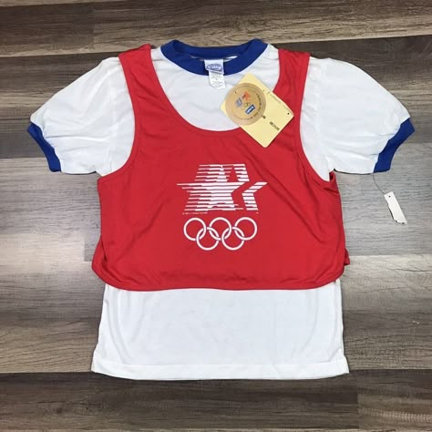 Vintage Levi's Womenswear Junior Ringer T-Shirt Usa Olympics 1984 Los Angeles. New Old Stock. Very Rare. The Red Top Is Sewn With The Ringer At The Shoulders Very Unique. Please Compare Measurements To Your Favorite Garments. Pit To Pit Roughly 16 Inches. Shoulder To Hem Roughly 23 Inches. We Try Our Best To Accurately Describe And Picture The Product Accurately. Lego Shirts, 90s Culture, 1984 Olympics, Tee Ideas, The Ringer, Culture Fashion, Sports Logo Design, Levis T Shirt, Brand Ideas