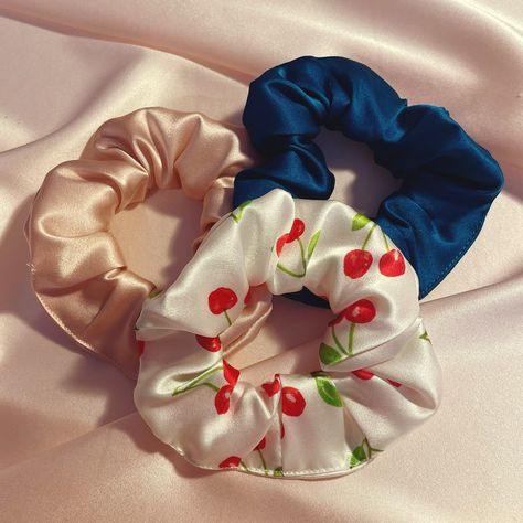 While I normally associate cherry prints with summer, I don’t want to stop posting just because autumn has decided to turn up early! Image description – a pale pink silk scrunchie, deep teal silk scrunchie and a white silk scrunchie with cherry print against a pale pink silk background #CherryPrint #HairAccessories #Scrunchies Silk Scrunchies Aesthetic, Pink Silk Background, Scrunchies Aesthetic, Silk Background, Silk Scrunchies, Image Description, Cherry Print, Deep Teal, White Silk