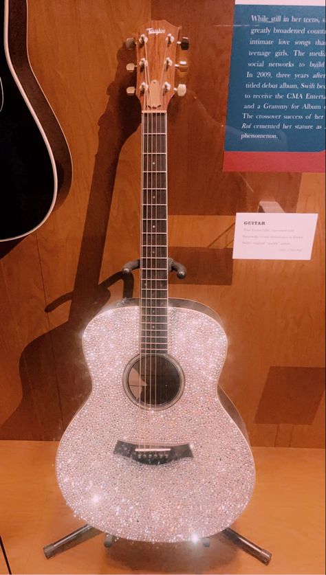 Taylor swifts iconic sparkle guitar located at the country music hall of fame in Nashville Taylor Swift Debut Guitar, Guitar Decorations, Taylor Swift Guitar, White Guitar, Country Music Hall Of Fame, Violin Design, Taylor Guitars, Taylor Outfits, Guitar Obsession