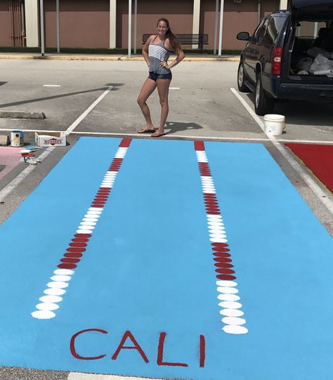 Swimmer painted parking spot Stitch Parking Spot Painting, Senior Parking Spaces Swimming, Car Window Paint, Painted Parking Spaces Ideas, Swim Team Party, Parking Lot Painting, Parking Spot Painting, Shark Painting, Parking Spot