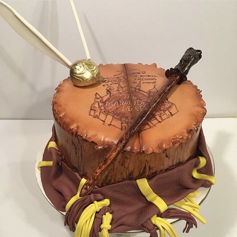 Harry Potter cake Gryffindor maroon and gum paste golden snitch gum paste wand marauders map Harry Potter Cake Gryffindor, Sweet 16 Birthday Cake, Harry Potter Food, 16 Birthday Cake, Marauders Map, Harry Potter Cake, Golden Snitch, 16 Birthday, Baby Gender Reveal