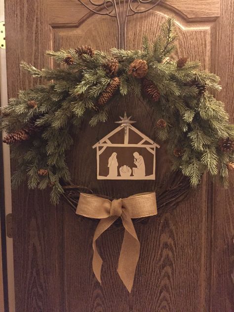 DIY Grapevine Christmas wreath. Garland/twigs with pine cones, Grapevine wreath, burlap ribbon, and a center decor of choice. I found the Nativity. Floral wire to make the twigs stay in place. Diy Nativity Wreath, Nativity Wreath Diy, Christian Christmas Wreath, Catholic Christmas Decorations, Christmas Wresth, Woodland Christmas Theme, Christian Christmas Decor, Sliding Gate Design, Grapevine Christmas Wreath