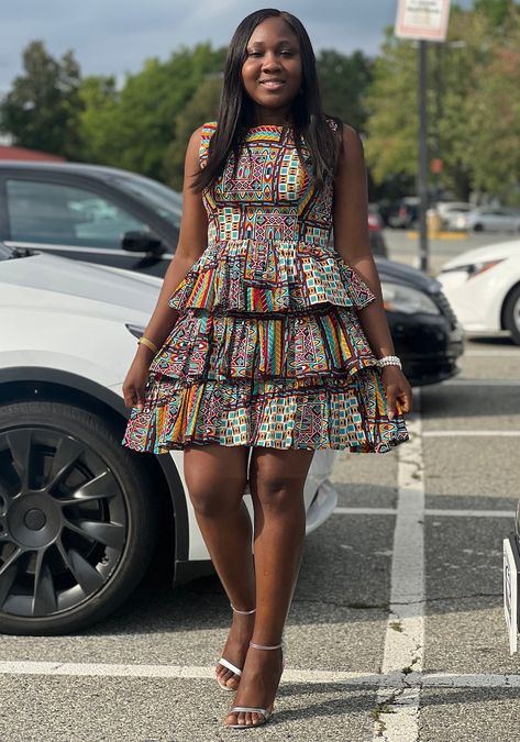 Our vibrant summer Short 3-layered sleeveless dress is crafted from African print Ankara. Elevate your look by pairing it with a blazer and various fashion accessories. Classic Gown, Steps Dresses, Ankara Long Gown, Ankara Gown, Short Dress Styles, Short Gowns, Fitted Midi Dress, Ankara Dress, African Print Fashion