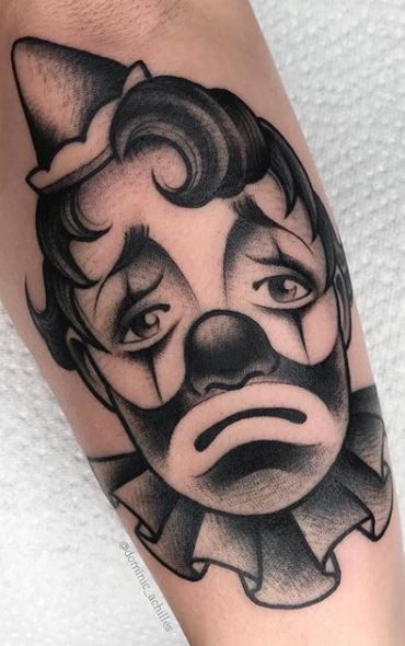 Clown Tattoos - Ideas & Meaning PLUS 24 Photos & Designs Jester Clown Tattoo, Clown Mask Tattoo, Clown Tattoo Simple, Happy Clown Tattoo, Clown Tattoo Outline, Clown Tattoo Traditional, Clown Traditional Tattoo, Traditional Tattoos Clown, Traditional Clown Tattoo