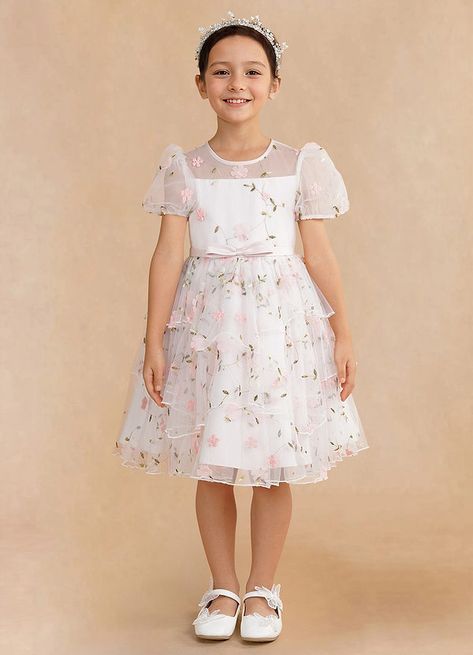 Bon Bon is our charming flower girl A-line dress made from our embroidered tulle. She features a scoop neckline with an inner bodice framed by adorable puff short sleeves. The keyhole back adds a touch of modern flair, while the bow belt adds a sweet accent. The tiered A-line skirt creates a playful and elegant silhouette, ideal for twirling at any special occasion. Pastel Flower Girl Dresses, Modern Flower Girl Dresses, Pink Flower Girl, Girls Spring Dresses, Girls Tea Party, Pink Flower Girl Dresses, Toddler Flower Girl Dresses, Tea Party Dress, Light Pink Flowers