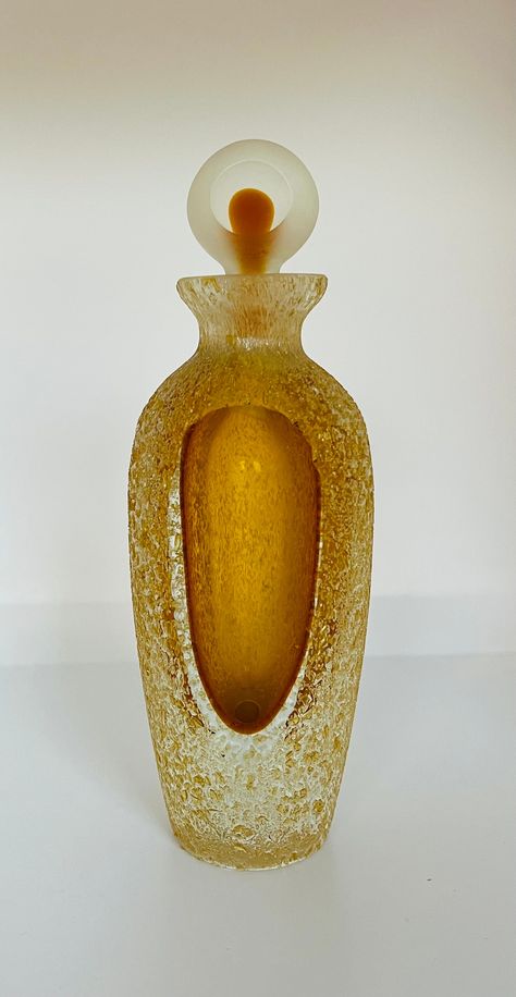 This exquisite vintage perfume bottle Is Crafted with meticulous attention to detail, this timeless elegant perfume bottle features a beautifully textured amber glass body that shimmers with rich, warm hues. The frosted glass stopper complements the design, creating a striking contrast that enhances its vintage charm. Perfect for collectors or as a unique gift, this perfume bottle is a stunning representation of vintage artistry. In excellent condition, has no chips, cracks or repair. Measures 6 Perfume Bottle Design Unique, Unique Perfume Bottles, Witch Cafe, Heart Perfume, Maximalist Jewelry, Elegant Perfume, Vintage Perfumes, Perfume Bottle Design, Perfume Bottle Art