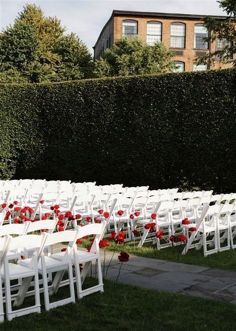 Imagine being led down the aisle by these exquisite red roses surrounded by a picturesque garden setting at this outdoor wedding ceremony. Walking down the aisle accompanied by a live harpist is so elegant. #outdoorweddingceremony #outdoorwedding #weddingceremony #redroses #harpist #weddingmusic #overthemoon #townandcountrymag #theknot #weddingplanner #nycweddingplanner #luxuryweddings #alinatoevents Wedding Aisle Red, Picturesque Garden, White Wedding Ceremony, Red Wedding Decorations, Rose Gown, Wedding Isles, Red And White Weddings, Ceremony Chairs, Red Rose Wedding