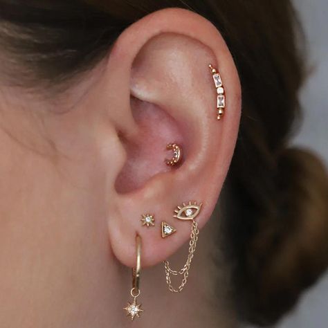 It's no secret that ear piercing is having a moment. From celebrities to supermodels and fashion bloggers, everyone is loving all the elevated earring options that have become available. And while we love nothing more than a good ear party, there's something to be said for a more curated ear look. Earrings are a great Tragus Piercing Earrings, Constellation Piercings, Different Ear Piercings, Ear Peircings, Types Of Ear Piercings, Curated Ear, Pretty Ear Piercings, Ear Crawler, Multiple Ear Piercings