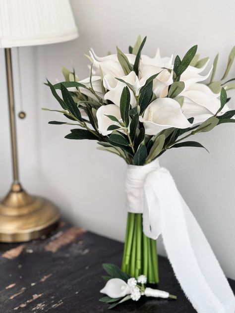 It consists of 24 artificial calla lila and olive branches. A very stylish and elegant bouquet. Comes with 1 boutonniere.