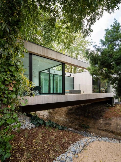 This modern house goes by the name name of the 'Bridge House', as it bridges over a small stream. #ModernArchitecture #ModernHouse Kindergarten Architecture, Bridge House, Arch House, Plans Architecture, Modern Architects, Glass Walls, House Modern, Bright Homes, Architecture Design Concept