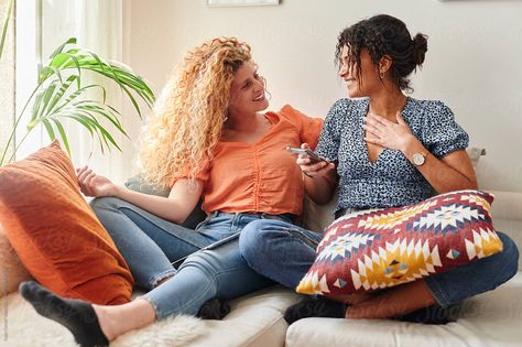 Two smiling young female friends looking at something on a cellphone while sitting together on a living room sofa Women Hanging Out, Sitting Together, Friends Hanging Out, Inspiration Images, Ikea Family, Dynamic Poses, Happy And Healthy, Friend Poses, Female Friends