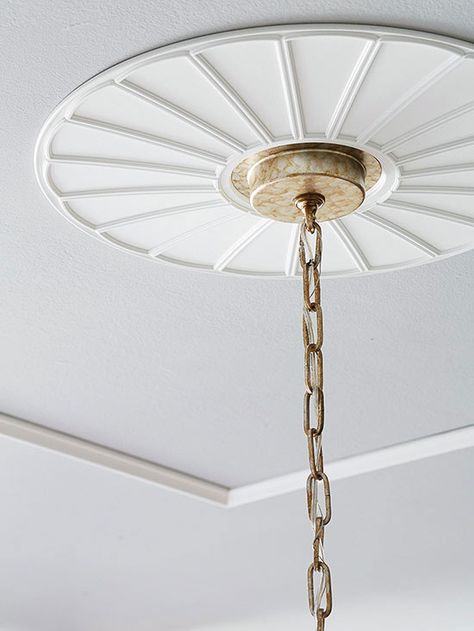 Architectural details are a great way to make a home look expensive. Turn the ceiling into a focal point with this simple trick: Embellish the area around a light fixture's attachment with a lightweight, polyurethane ceiling medallion. Decorative ceiling medallions are available in various sizes and can be painted in your desired hue. How to Install a Ceiling Medallion Decorative Ceiling Panels, Hanging Curtain Rods, Budget Remodel, By Any Means Necessary, Old Lights, Exterior Makeover, Decorative Ceiling, Look Expensive, Blue Curtains