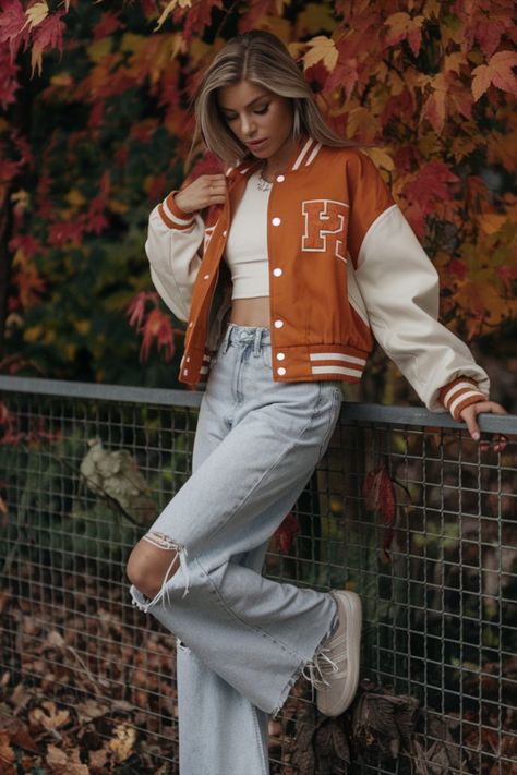 Rock the season in style with this varsity jacket and high-waist distressed jeans look. Find more fall style inspo on my profile! Vintage Letterman Jacket Outfit, Varsity Photoshoot, Vintage Letterman Jacket, Letterman Jacket Outfit, Effortless Fall Outfits, College Outfit, Jeans Look, Varsity Jackets, Senior Photoshoot