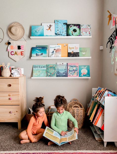 SEASHELL LIGHT LINKED HEREBUNNY BASKET LINKED HERESWIMSUITS LINKED HERE.SHELVES AND DRESSER ARE IKEA. WHITE BOOKSHELF IS THRIFTED. Book Shelves Kids, Kids Book Display Shelf, Beach Toy Library, Open Book Shelf For Kids, Magazine Rack Childrens Books, Children’s Book Shelves, Mermaid School, Reading Wall, Toddler Summer