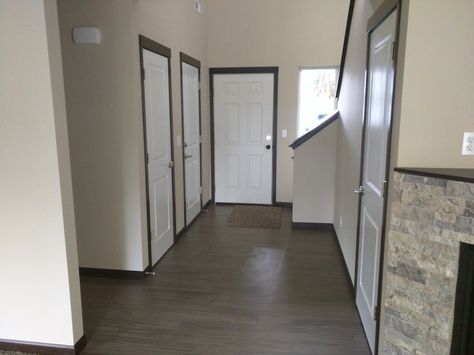 Dark Trim With White Doors, White Doors Dark Trim, White Door Dark Trim, Dark Trim White Doors, Grey Paint Living Room, Hallway Doors, Grey Floors, Stained Wood Trim, White Interior Door