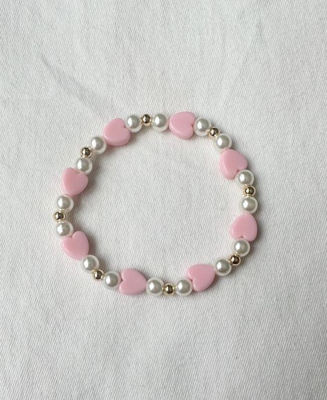 "A beautiful stretch bracelet with faux pearls, gold-plated beads, and soft pink hearts. Bracelet is 7\"." Bracelet Beads Design, Bead Bracelet Design Ideas, Coquette Bracelets, Bracelet Ideas Gold, Heart Beaded Bracelets, Bracelet Design Ideas, Heart Bead Bracelet, Hearts Bracelet, Valentines Bracelets